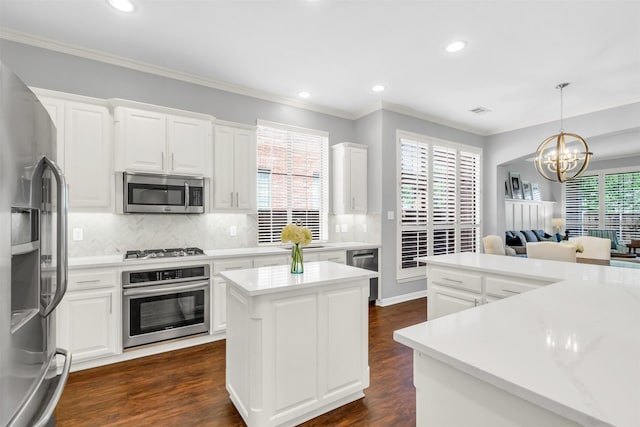 6424 Wind Song Dr, Mckinney, TX 75071 - kitchen featuring stainless steel appliances, a center island, a chandelier, decorative backsplash, and white cabinets
