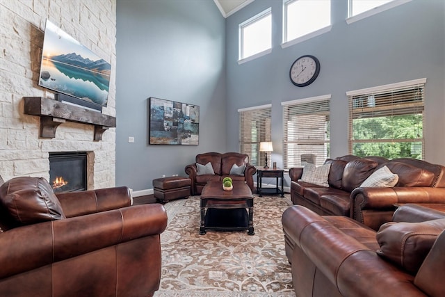2833 Macquarie St, Trophy Club, TX 76262 - living room featuring ornamental molding, a towering ceiling, wood finished floors, a fireplace, and baseboards