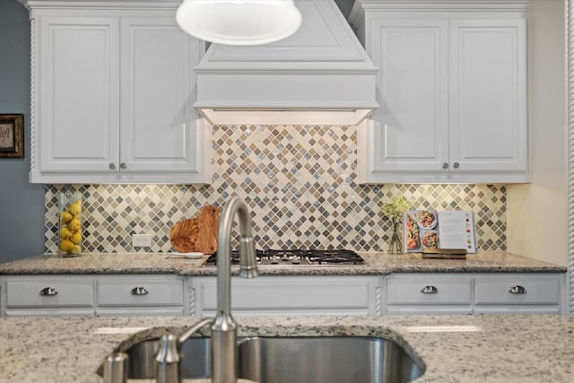 2833 Macquarie St, Trophy Club, TX 76262 - kitchen with a sink, white cabinetry, premium range hood, and tasteful backsplash