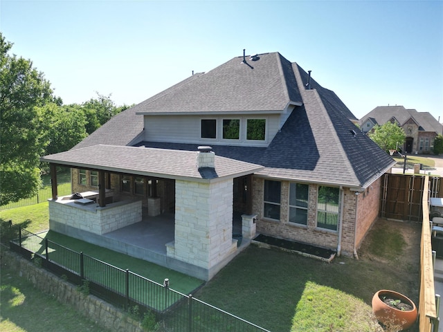 2833 Macquarie St, Trophy Club, TX 76262 - back of house featuring roof with shingles, brick siding, a fenced backyard, a lawn, and a patio