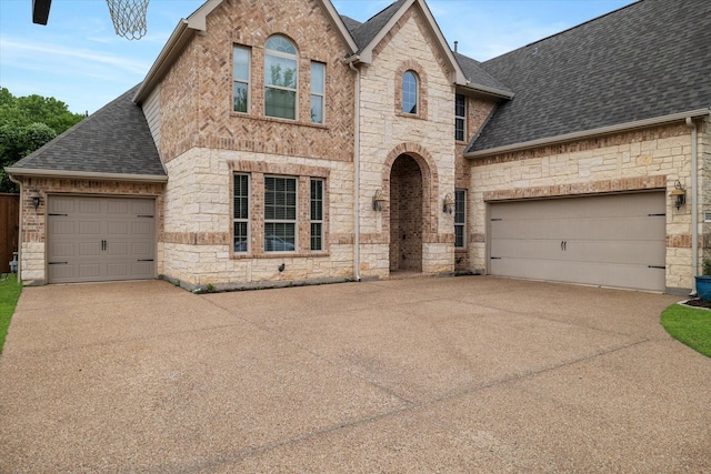2833 Macquarie St, Trophy Club, TX 76262 - french country inspired facade with a garage, driveway, stone siding, and a shingled roof