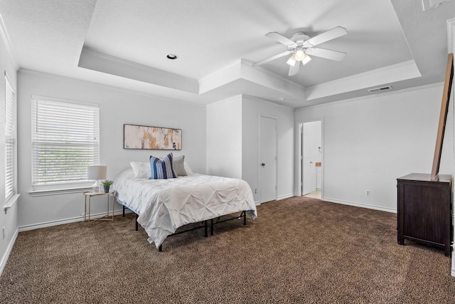 bedroom featuring crown molding, a raised ceiling, and carpet