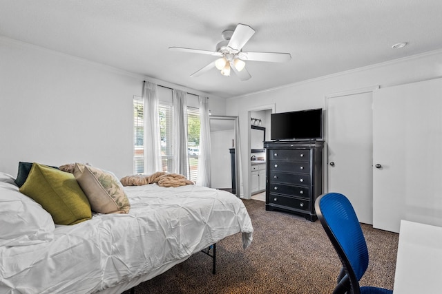 bedroom featuring crown molding, a ceiling fan, dark carpet, and connected bathroom