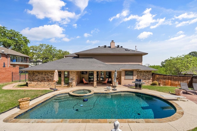 view of swimming pool featuring a patio area, fence, a pool with connected hot tub, and a grill