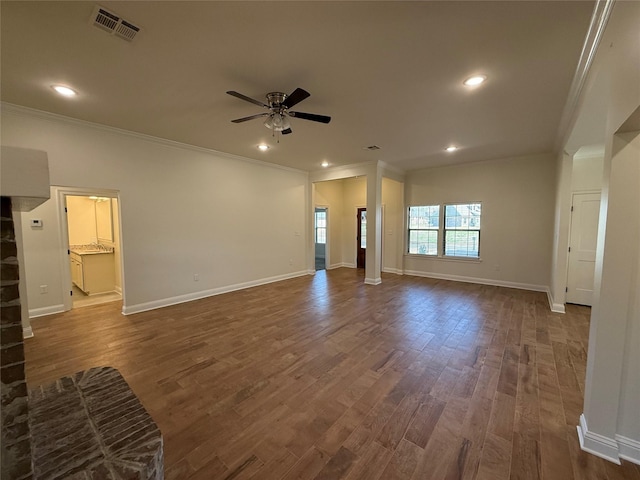 unfurnished living room with dark wood finished floors, visible vents, a ceiling fan, and ornamental molding