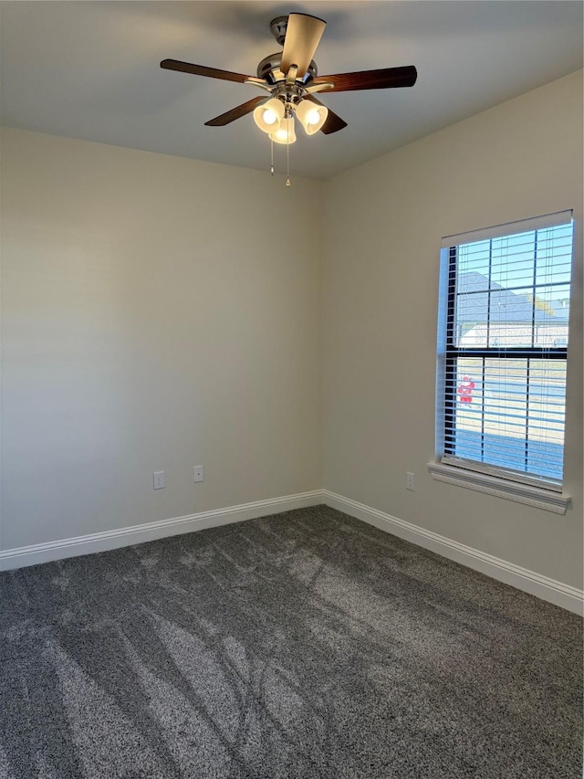 unfurnished room featuring dark carpet, ceiling fan, and baseboards