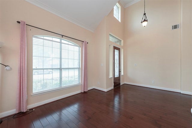 interior space featuring baseboards, visible vents, and ornamental molding