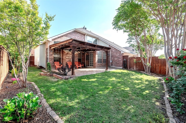 back of property featuring a fenced backyard, brick siding, a patio area, and a yard
