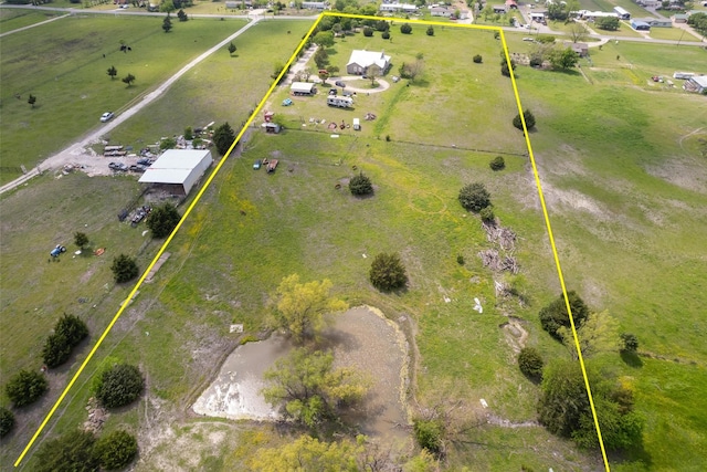 birds eye view of property with a rural view
