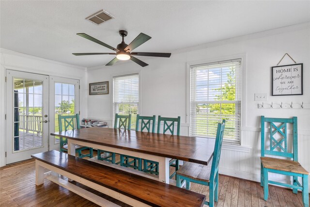 dining area featuring crown molding, french doors, hardwood / wood-style floors, a ceiling fan, and visible vents