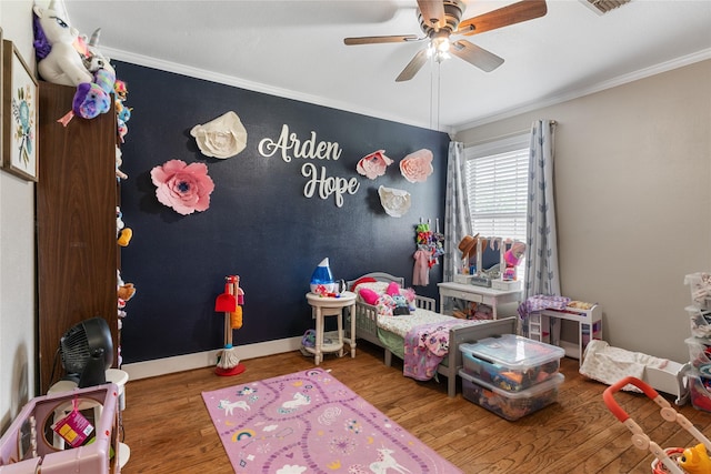 bedroom featuring ceiling fan, ornamental molding, and wood finished floors