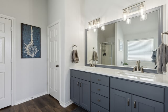 2820 Lone Ranger Trl, Little Elm, TX 75068 - full bathroom featuring a shower stall, wood finished floors, double vanity, and baseboards