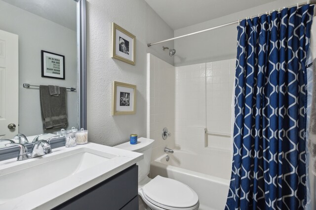 2820 Lone Ranger Trl, Little Elm, TX 75068 - bathroom with toilet, vanity, shower / tub combo with curtain, and a textured wall