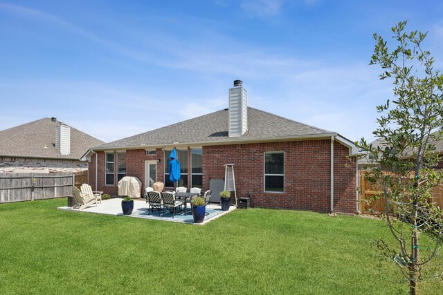 2820 Lone Ranger Trl, Little Elm, TX 75068 - back of property featuring brick siding, a patio area, a chimney, and a shingled roof
