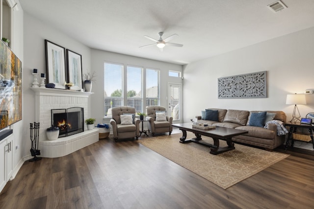 2820 Lone Ranger Trl, Little Elm, TX 75068 - living area with a ceiling fan, a brick fireplace, and dark wood-style floors
