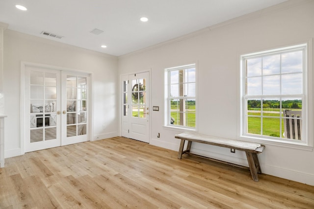 3823 Bluebonnet Trl, Princeton, TX 75407 - entrance foyer with light wood finished floors, french doors, ornamental molding, baseboards, and recessed lighting