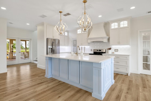 3823 Bluebonnet Trl, Princeton, TX 75407 - kitchen featuring appliances with stainless steel finishes, custom range hood, a chandelier, light countertops, and a sink