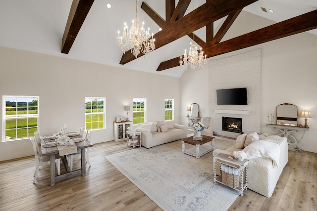 3823 Bluebonnet Trl, Princeton, TX 75407 - living room with a chandelier, high vaulted ceiling, beam ceiling, a large fireplace, and wood finished floors