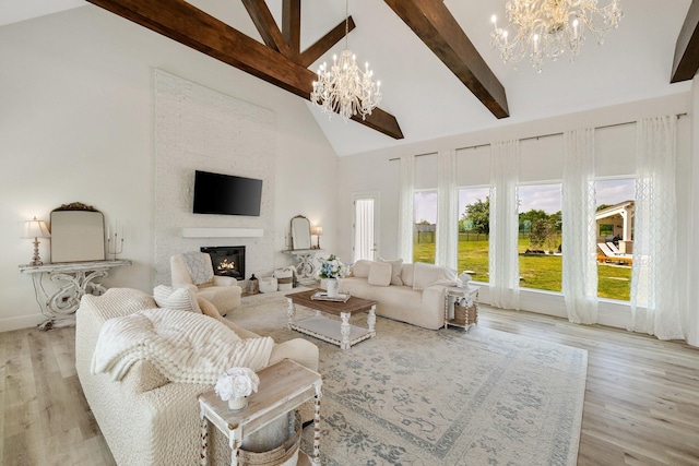 3823 Bluebonnet Trl, Princeton, TX 75407 - living room featuring a chandelier, beam ceiling, high vaulted ceiling, a fireplace, and light wood-type flooring