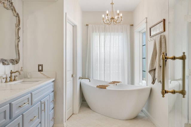 3823 Bluebonnet Trl, Princeton, TX 75407 - full bath featuring vanity, a chandelier, a freestanding bath, and baseboards