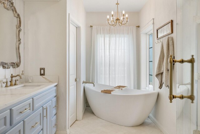 3823 Bluebonnet Trl, Princeton, TX 75407 - full bath featuring a chandelier, a soaking tub, vanity, and baseboards