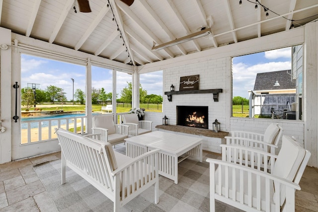 3823 Bluebonnet Trl, Princeton, TX 75407 - sunroom featuring track lighting, a ceiling fan, and an outdoor living space with a fireplace
