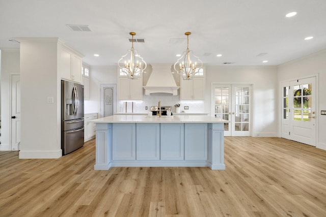3823 Bluebonnet Trl, Princeton, TX 75407 - kitchen with appliances with stainless steel finishes, custom range hood, light countertops, white cabinetry, and tasteful backsplash