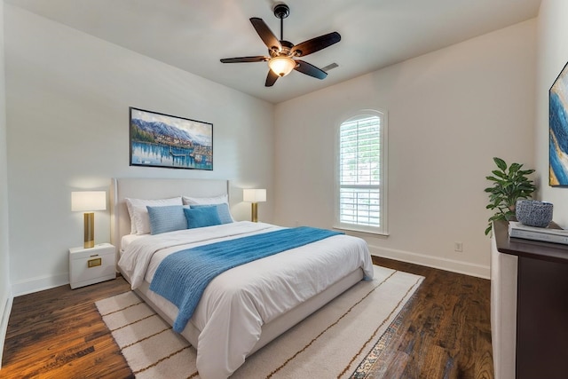bedroom featuring a ceiling fan, baseboards, visible vents, and dark wood-style floors
