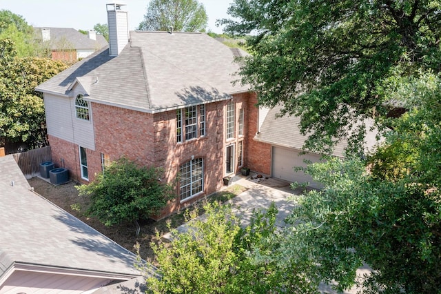 1727 Parkwood Dr, Grapevine, TX 76051 - view of home's exterior with brick siding, a garage, a chimney, and a shingled roof