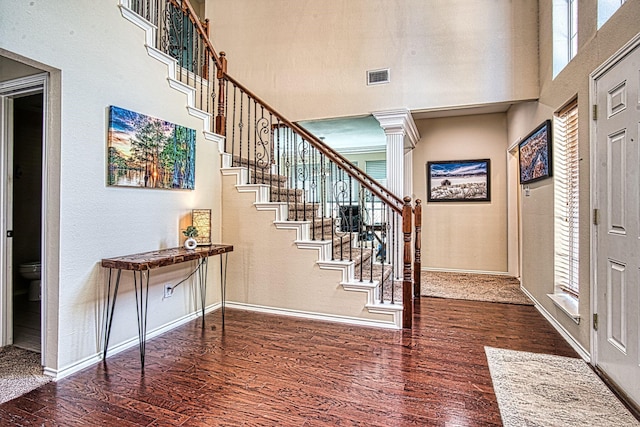 1727 Parkwood Dr, Grapevine, TX 76051 - foyer entrance with a high ceiling, wood finished floors, baseboards, stairway, and ornate columns