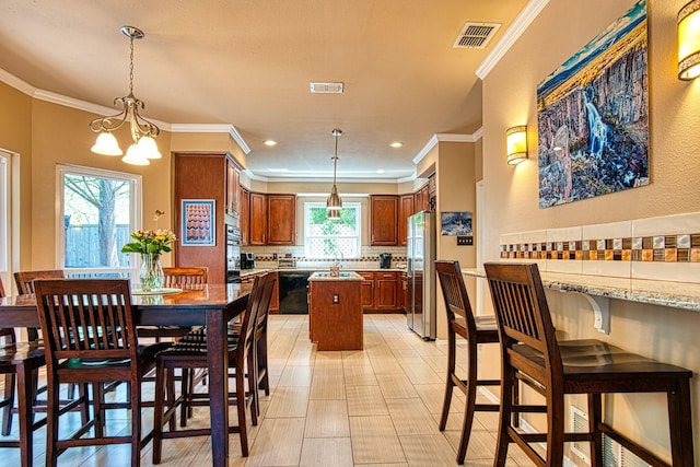 1727 Parkwood Dr, Grapevine, TX 76051 - dining space with ornamental molding and a chandelier