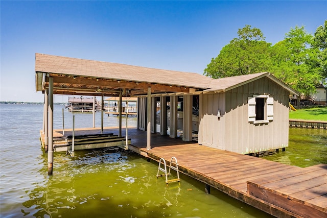 dock area with a water view and boat lift