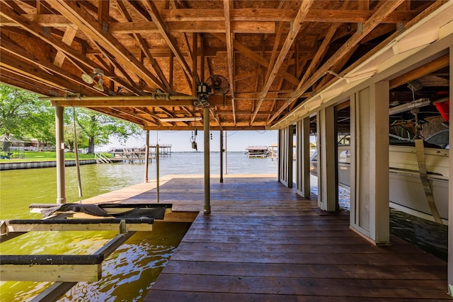 dock area with boat lift and a water view
