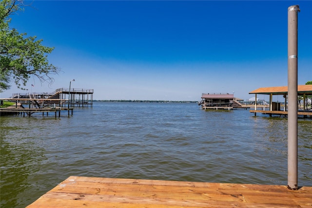 view of dock featuring boat lift and a water view