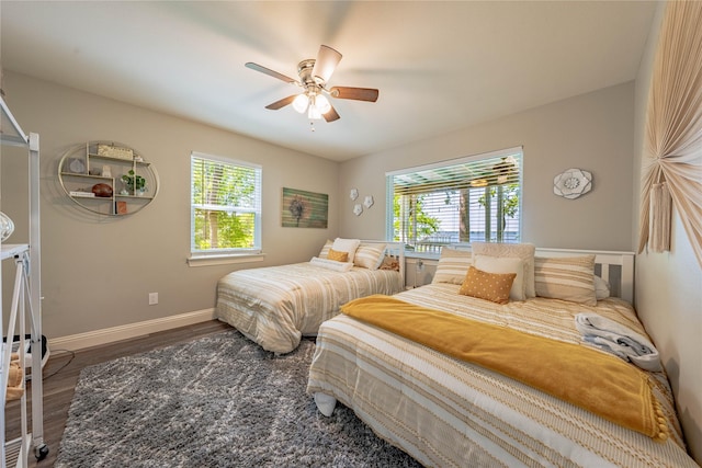 bedroom with baseboards, a ceiling fan, and wood finished floors