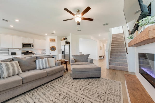 14620 Serrano Ridge Rd, Fort Worth, TX 76052 - living area with stairs, light wood-style flooring, recessed lighting, and a ceiling fan