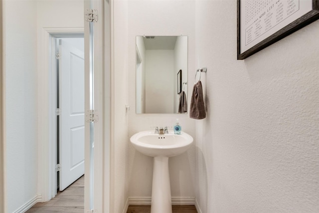 14620 Serrano Ridge Rd, Fort Worth, TX 76052 - bathroom featuring baseboards, wood finished floors, and a sink