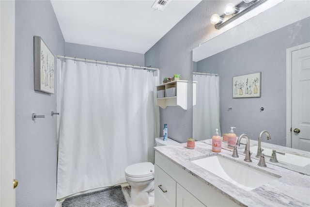 5428 Redwater Ct, The Colony, TX 75056 - bathroom featuring toilet, vanity, and a shower with shower curtain
