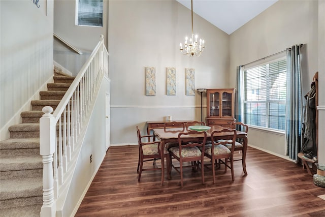 5428 Redwater Ct, The Colony, TX 75056 - dining area with high vaulted ceiling, stairs, dark wood-style floors, a chandelier, and baseboards