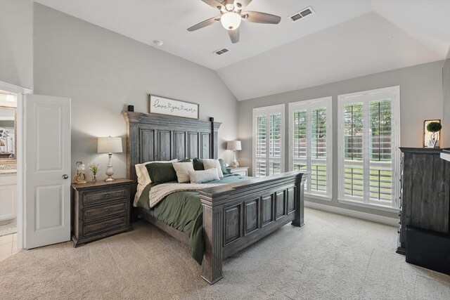 bedroom with light carpet, vaulted ceiling, and visible vents