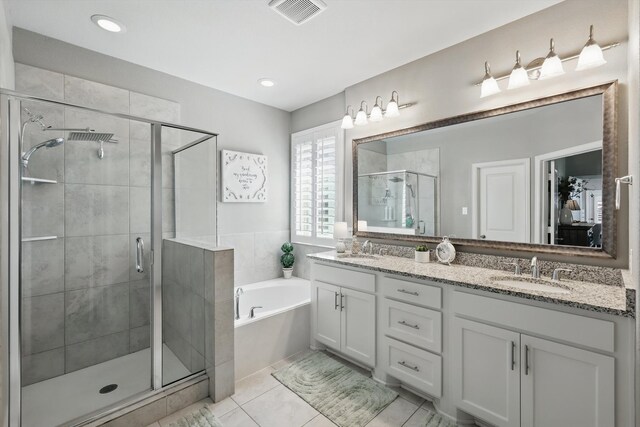 bathroom featuring a sink, a shower stall, a bath, and visible vents