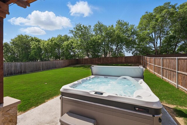 view of yard with a hot tub and a fenced backyard