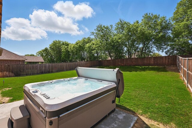 view of yard featuring a fenced backyard and a hot tub