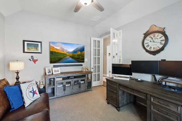 office space with french doors, a ceiling fan, light carpet, and vaulted ceiling