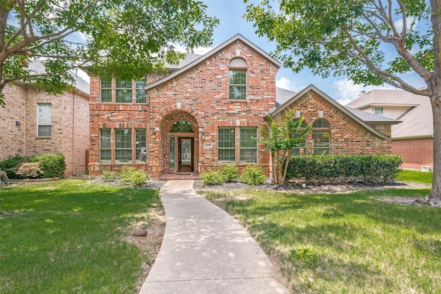 1370 Misty Cv, Rockwall, TX 75087 - traditional-style home with brick siding, a front lawn, and roof with shingles