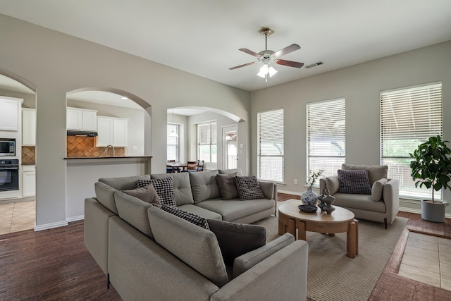 1370 Misty Cv, Rockwall, TX 75087 - living room with arched walkways, a ceiling fan, plenty of natural light, and dark wood-style floors