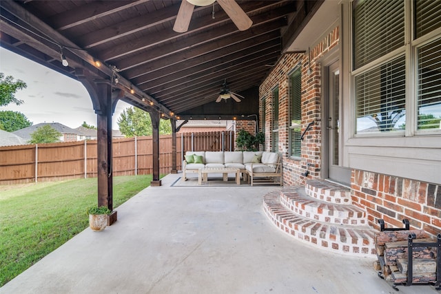 1370 Misty Cv, Rockwall, TX 75087 - fenced backyard featuring ceiling fan, an outdoor hangout area, and a patio