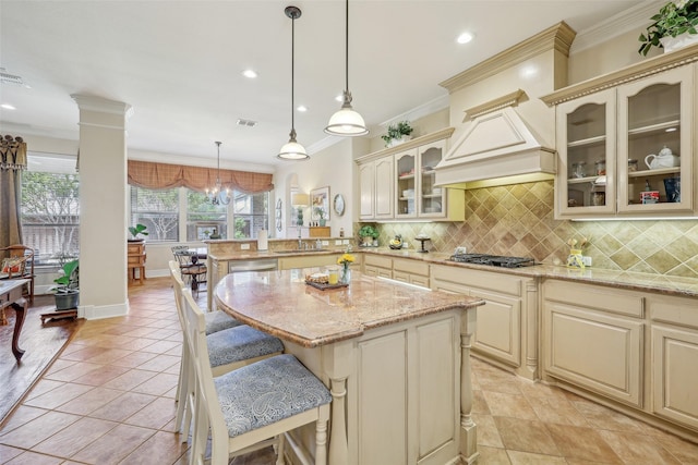 7905 Trixie Trail Dr, Mckinney, TX 75070 - kitchen featuring cream cabinetry, a peninsula, ornamental molding, stainless steel gas cooktop, and recessed lighting