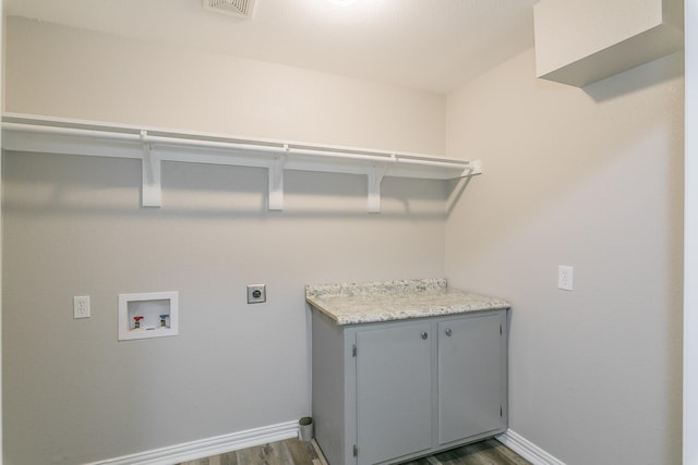 clothes washing area with baseboards, hookup for an electric dryer, dark wood-style flooring, and washer hookup
