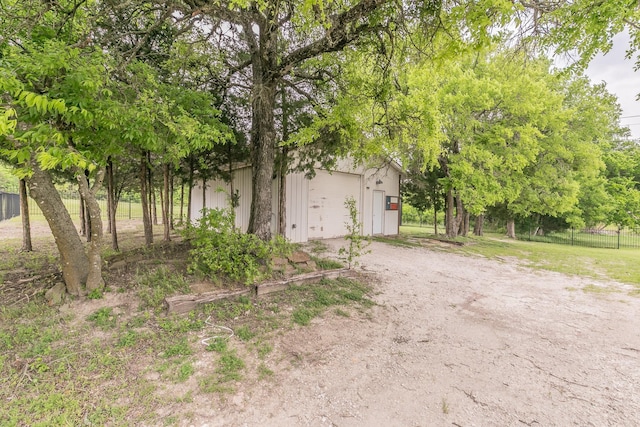 exterior space featuring fence and driveway